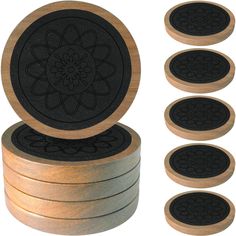 six wooden coasters with black and gold designs on the top one has a flower design