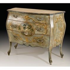 an antique chest with painted designs on the front and drawers, in gold leaf trimmings