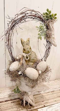 a wreath with an animal and eggs in it