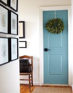 a blue door with a wreath hanging on it