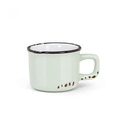 a white and black coffee cup on a white background with brown spots around the rim