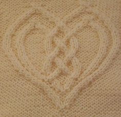 a knitted blanket with two hearts drawn on it