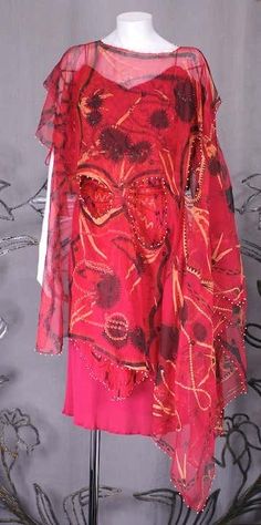 For Sale on 1stDibs - Cocktail dress of cherry red rayon matte jersey overlaid with a micropleated chiffon overdress in a handpainted design by Zandra Rhodes. All the chiffon Red Silk Festival Dress, Punk Gown, Zandra Rhodes, Safety Pins, Cherry Red, Rhodes, Safety Pin, Kimono Top, Evening Dresses