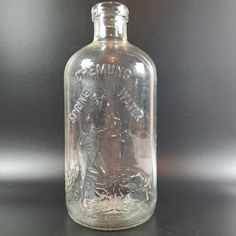 a glass bottle with an image on it