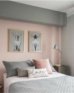 two framed pictures hang on the wall above a bed with pink and gray decor in a bedroom