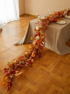 the table is set with plates and place settings for an autumn themed dinner or party