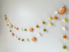 an orange and white garland hanging on the wall