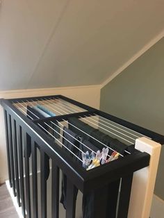 clothes are hanging on the rails in an upstairs space that has been painted gray and white