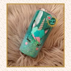 a green glitter tumbler with an image of a unicorn on it