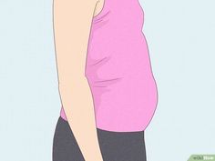 a pregnant woman in pink shirt and black skirt standing with her hands on her hips