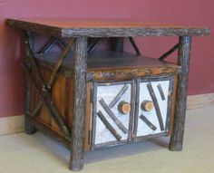 an old wooden table with two drawers and some wood sticks on the bottom one side