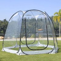 an outdoor shower in the middle of a grassy area with palm trees and blue sky behind it