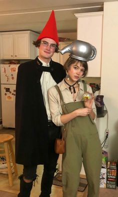 two people dressed up in costumes standing next to each other and posing for the camera