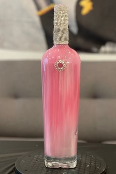 a pink bottle sitting on top of a table