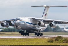 an airplane is taking off from the runway with it's landing gear down and two other planes in the background