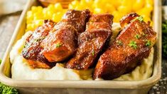 some meat and potatoes in a pan on a table