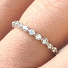 a woman's hand with a diamond ring on it