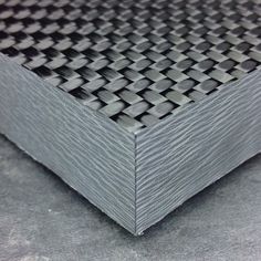 a close up view of a metal surface with squares on the top and bottom part