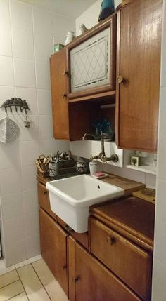 a kitchen with wooden cabinets and a white sink