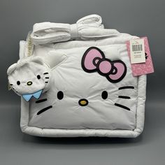 Hello Kitty & Dear Daniel Puffer Tote Bag With Coin Purse Carry Your Essentials In Kawaii Style With This Hello Kitty Tote Bag! Featuring An Adorable Puffy Design Of Hello Kitty’s Face With Her Signature Bow. Comes With A Detachable Dear Daniel Coin Purse And An Interior Zipper Pocket. * 13'' X 4'' X 11'' * Polyester * Interior Zipper Pocket * Detachable Coin Purse * Imported Hello Kitty Dear Daniel, Hello Kitty Tote Bag, Hello Kitty Tote, Puffer Tote Bag, Puffy Design, Dear Daniel, Sanrio Bag, Sanrio Accessories, Purse White