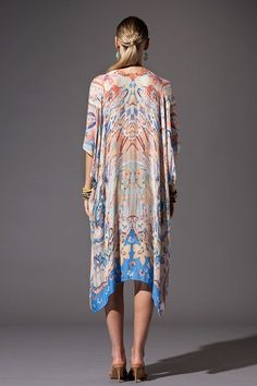 This kimono showcases a floral and Ikat print, with a mid-length style, side slits, and an open front design. Offering a lightweight and soft material, it is essential for summer and can be worn at the lake, beach, or pool as well as a wrap for a casual look. Relaxed, Oversized Fit 1/2 Length Kimono Sleeves Mid-length Side Slits Open Front Bohemian Style One size fits most Length: 38" Width: 40" Patterned Kaftan For Summer Beach Cover-up, Spring Bohemian Kaftan With Abstract Print, Summer Festival Open Front Kaftan, Summer Patterned Kimono For Beach Cover-up, Spring Printed Wrap Kaftan, Bohemian Kimono With Abstract Print For Vacation, Spring Kaftan With Kimono Sleeves For Daywear, Festival Printed Open Front Kaftan, Spring Daywear Kaftan With Kimono Sleeves