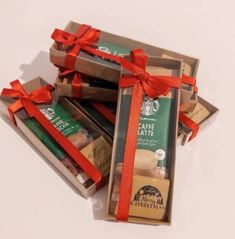 several chocolate bars wrapped in red ribbon on top of each other with coffee beans and cinnamons