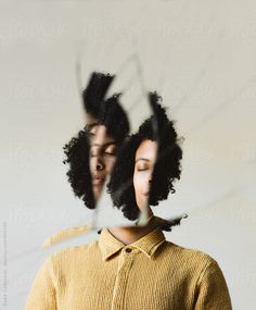 two women with their faces reflected in the mirror by an image of one woman's head