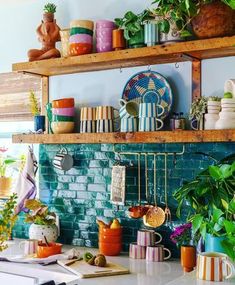 a kitchen counter with pots and pans on top of it next to a brick wall