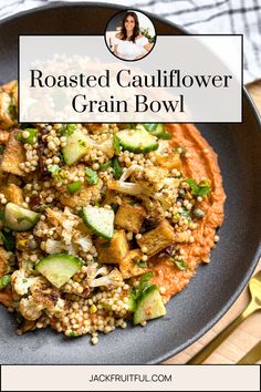 roasted cauliflower grain bowl on a plate with a fork and spoon next to it