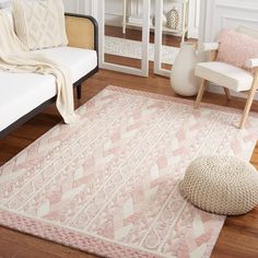 a white and pink rug in a living room