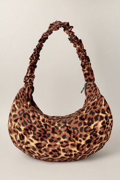 Accessorize with a statement shoulder bag that's luxuriously appointed with a leopard print. Ideal for both daytime or a night out. Leopard Print Ruched Top Handle Top Zip Closure Size: Approx. 16.5" W x 9"H Leopard Print Bags For Fall, Leopard Print Shoulder Bag With Detachable Strap For Evening, Evening Shoulder Bag In Leopard Print With Detachable Strap, Evening Leopard Print Shoulder Bag With Detachable Strap, Leopard Print Travel Bag For Fall, Chic Leopard Print Tote Shoulder Bag, Chic Leopard Print Shoulder Bag For Travel, Chic Leopard Print Bag With Double Handles, Chic Double Handle Bag In Leopard Print