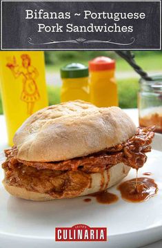 a pulled pork sandwich on a plate with barbecue sauce