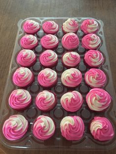 cupcakes with pink and white frosting in a plastic container