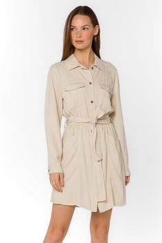 Add some sophistication to your wardrobe with the Deena Dress. This soft mini shirtdress features a stylish collar and snap button closure. With long sleeves and functional pockets, it's both practical and trendy. Complete the look with the self-belt for a flattering fit. Material: 60% Tencel™ and 40% Linen Machine wash cold or dry clean Color: Wheat Model is 5'9" and wearing a size S Imported Collared Mini Dress For Daywear With Belt, Mini Shirt Dress With Pockets For Daywear, Fall Mini Length Belted Dress, Spring Collared Mini Dress For Work, Collared Mini Dress For Spring Workwear, Spring Shirt Dress With Spread Collar, Spring Shirt Dress With Spread Collar For Work, Casual Spring Mini Dress With Collared Neckline, Spring Workwear Shirt Dress With Spread Collar