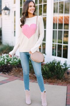 This sweater is here for all of your love! That knit heart is so cute! This sweater is absolutely perfect for Valentine's Day but we think it will also be perfect for any day of the week! Round neckline Long sleeves Cable knit heart Generous stretch Sydney is wearing the small. Valentines Chenille Sweater, Cute Heart Print Crew Neck Sweater, Cute Cream Crew Neck Sweater, Pink Knit Sweater With Heart Print, Cute Winter Sweater With Heart Print, Cute Heart Print Winter Sweater, Cute Long Sleeve Sweater For Valentine's Day, Cute Long Sleeve Valentine's Day Sweater, Cute Winter Sweater With Heart Graphic