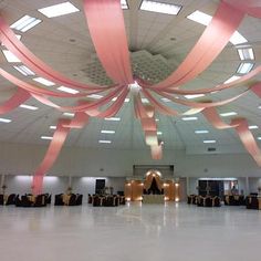 the ceiling is decorated with pink ribbons and lights