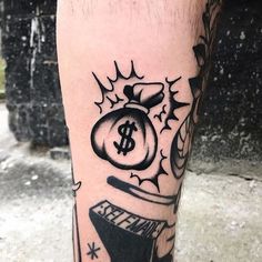 a man's leg with a tattoo on it that has money in a bag