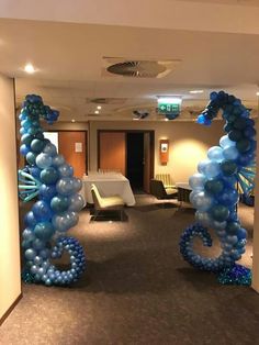 balloons in the shape of animals are on display at an office lobby event for people to attend