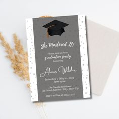 a graduation party card with a mortar cap and stars on the front, sitting next to a