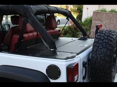 the back end of a white truck with red seats