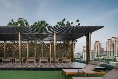 an outdoor seating area with lounge chairs and a pergolated roof