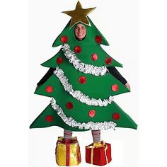 a cardboard christmas tree with presents under it and a smiling man in the middle,