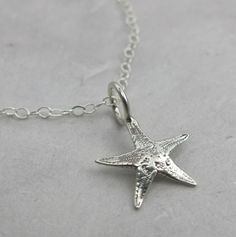 small starfish necklace in sterling silver Ocean-inspired Sterling Silver Jewelry With Starfish Charm, Ocean-inspired Sterling Silver Charm Necklaces, Ocean-inspired Silver Sterling Charm Necklaces, Silver Starfish Charm Necklace In Sterling Silver, Sterling Silver Starfish Charm Pendant Necklace, Sterling Silver Starfish Necklace With Star Charm, Sterling Silver Necklace With Starfish Charm, Sterling Silver Pendant Necklace With Starfish Charm, Star-shaped Sterling Silver Jewelry With Lobster Clasp