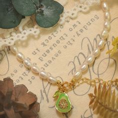 Savor the elegance and luxury of our Avocado Pearl Bracelet. Carefully curated pearls are strung together with precision and adorned with a fresh green avocado enameled charm, adding a delightful touch of color. Made with 18K gold on brass, this stunning piece exudes sophistication. Perfect for both casual outings and special occasions, this bracelet will ensure you stand out with its unique and captivating design. Details Plating: 18K Gold Materials: 18K Gold on Brass, Enamel, Freshwater Pearls Green Pearl Beaded Bracelets As Gift, Green Pearl Beaded Bracelets, Fruit Bracelet, Green Avocado, Fruit Jewelry, Enamel Charms, Fresh Green, Pearl Size, Gold Material