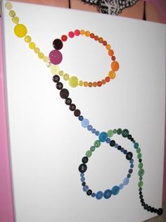 a white board with buttons and beads on it