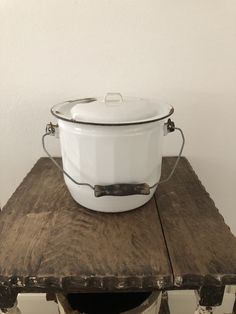 a large white pot sitting on top of a wooden table