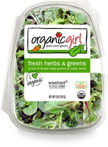 organic fresh herbs and greens in a plastic container on a white background with clippings