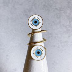 "This super cool ring makes quite a statement, featuring a twisted, gold-plated spiral band with enamel evil eye charms on either end. The ring measures almost 1 3/4\" in length (top to bottom). It may extend past halfway up your finger, but has some flexibility to it. It is a US size 7 and cannot be adjusted. Perfect for the lover of evil eye jewelry! ▻ Size: 7 (not adjustable!) ▻ Lead and nickel-free ▻ Handmade in Santa Cruz, CA To preserve the metal finish, please do not wear your rings while Armor Rings, Armor Ring, Finger Rings, Evil Eye Charm, Evil Eye Jewelry, Eye Jewelry, Lace Edging, Pink Candy, Blue Rings