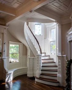 a staircase leading up to the second floor in a house with white walls and wood floors