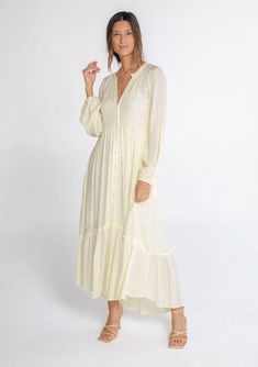 A classic bohemian maxi dress in a billowy silhouette, designed in textured checkered jacquard. This dreamy and versatile style features long voluminous sleeves, a delicate self-covered button front, and a ruffle-trimmed neckline. The tiered skirt adds shape and movement. Try this timeless style unbuttoned over denim! Checkered jacquard Relaxed, flowy fit Long voluminous sleeves Elastic wrist cuffs Maxi length Ruffle-trimmed tiered skirt Ruffle-trimmed round neckline Self-covered button front Si Flowy Maxi Dress Fall, Flowy Bohemian Dress, Long Sleeve Maxi Dress Fall, Shabbat Outfit, Long Sleeved Maxi Dress Fall, Maxi Dress Fall, Button Down Maxi Dress, Dusty Teal, Skirt Ruffle